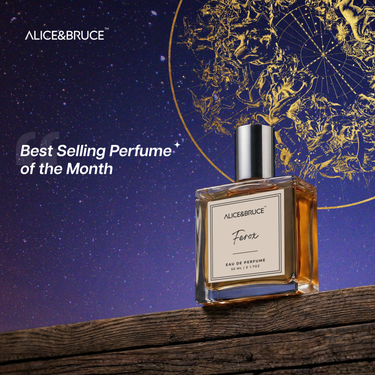 Perfume bottle labeled 'Alice & Bruce' on a wooden surface with a starry night sky and celestial design in the background.