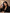 Elegant woman holding Alice and Bruce Aqua perfume in a luxury portrait setting